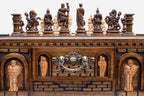 Close-up of the carved figural chess pieces, arched niche sentinels and ornate brass drawer handle