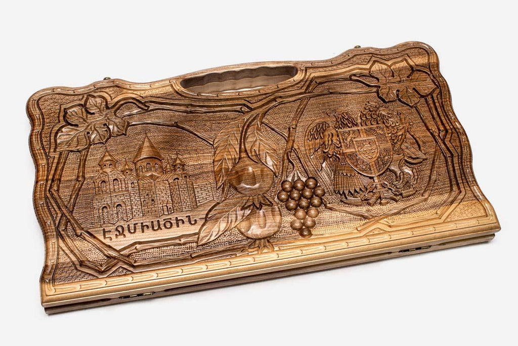Angled view of the four scenes carved walnut backgammon board