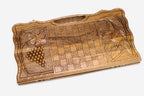 Angled view of the two scenes carved walnut backgammon board
