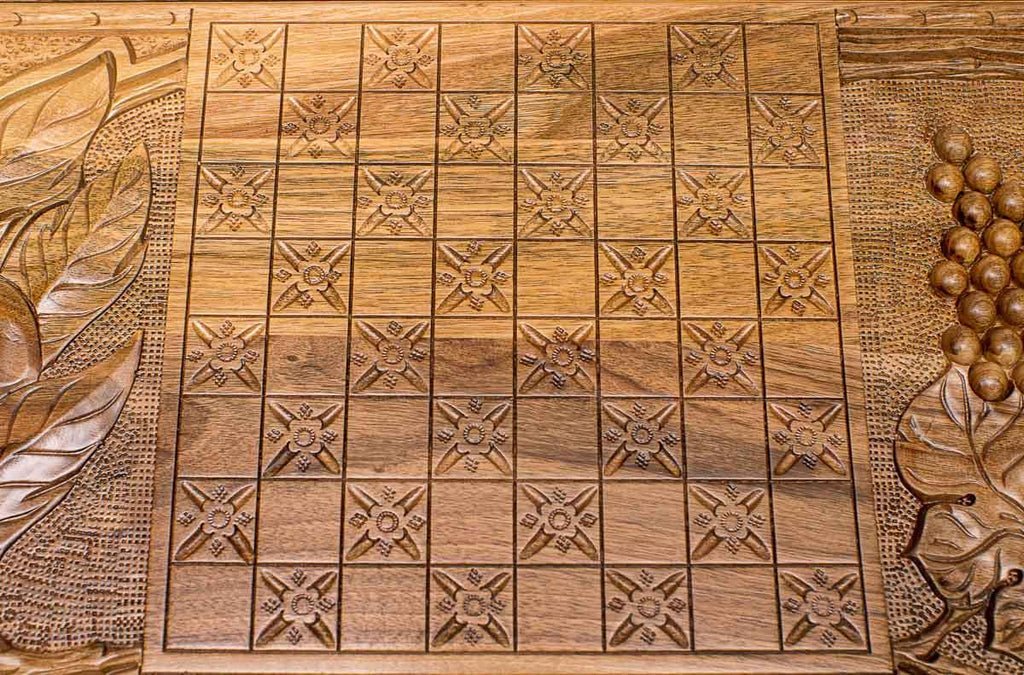 The backgammon board opened to show the wooden playing surface