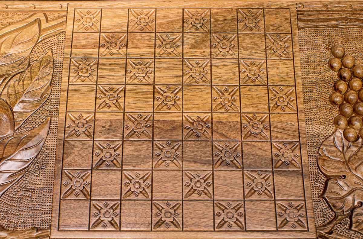 The backgammon board opened to show the wooden playing surface