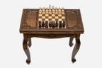 Scalloped chess and backgammon table set up for chess, straight front view