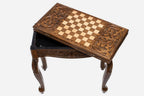 Scrollwork table opening to reveal the backgammon compartment