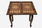 Scrollwork chess and backgammon table with chess pieces set up, angled view
