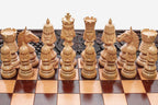 Regal carved figures on a wooden chess set - side view
