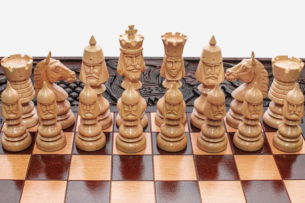 Regal carved figures on a wooden chess set - side view