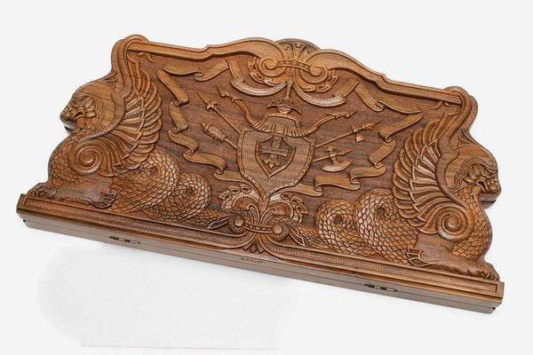 Master-carved walnut backgammon board with twin dragons flanking a central emblem, propped open