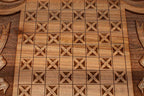 The backgammon board opened to show the wooden playing surface