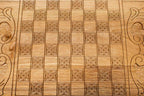 The backgammon board opened to show the wooden playing surface