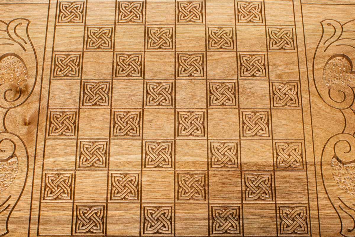 The backgammon board opened to show the wooden playing surface