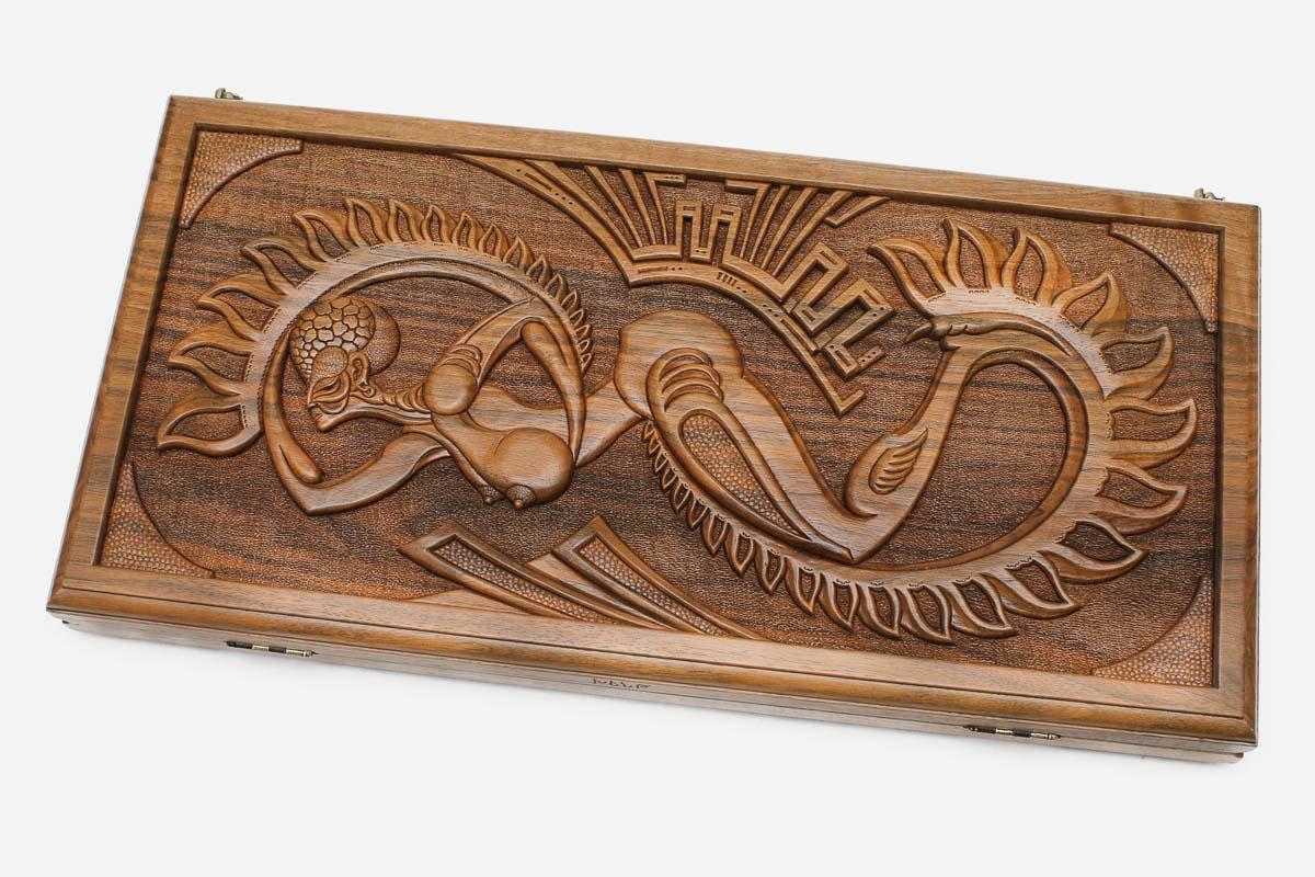 Master-carved walnut backgammon board with a surreal Martian design, propped open
