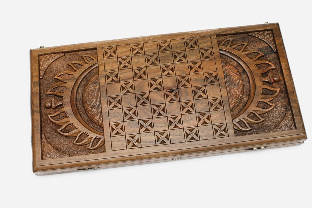 Angled view of the Martian master carved walnut backgammon board