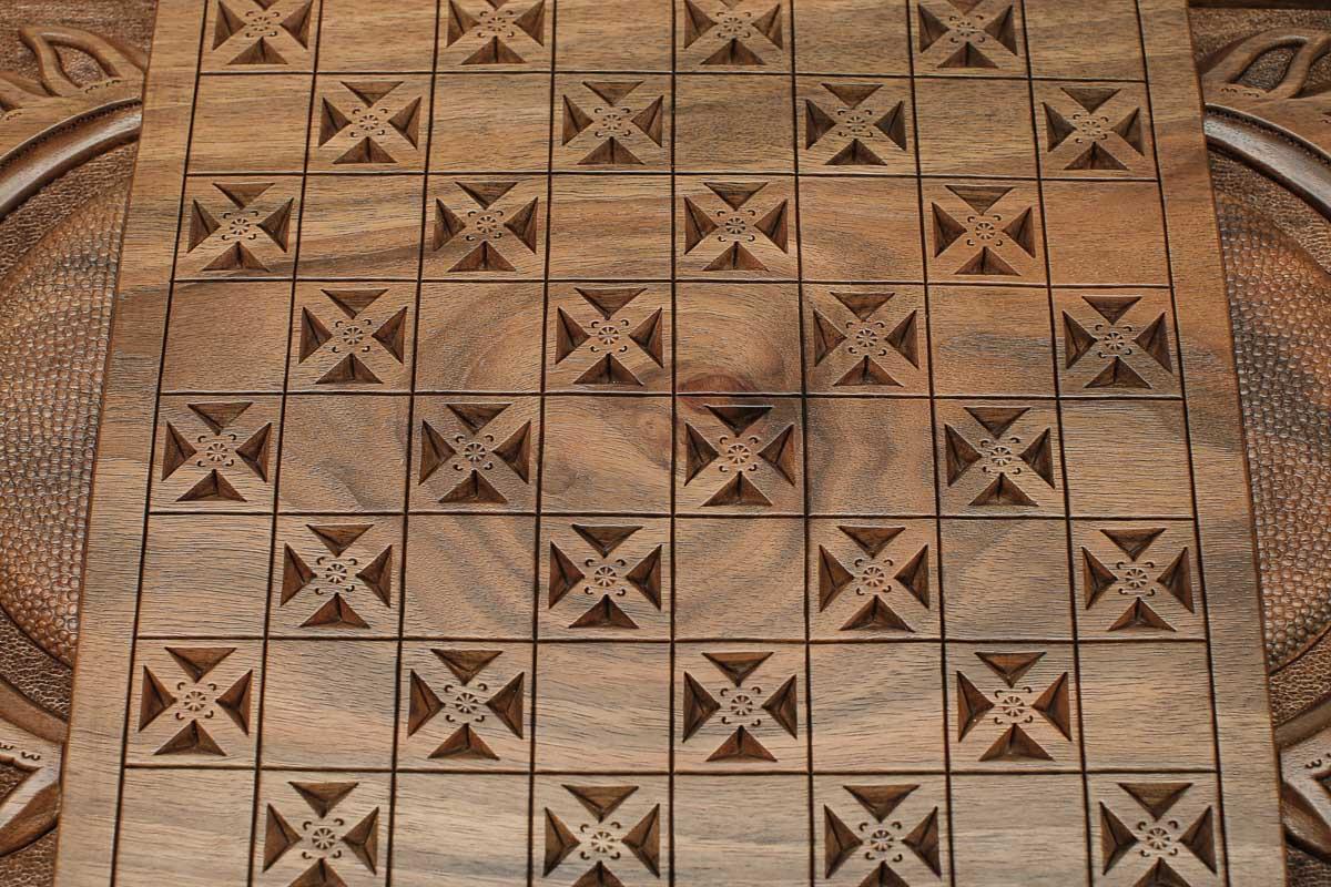 The backgammon board opened to show the wooden playing surface
