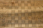 The backgammon board opened to show the wooden playing surface