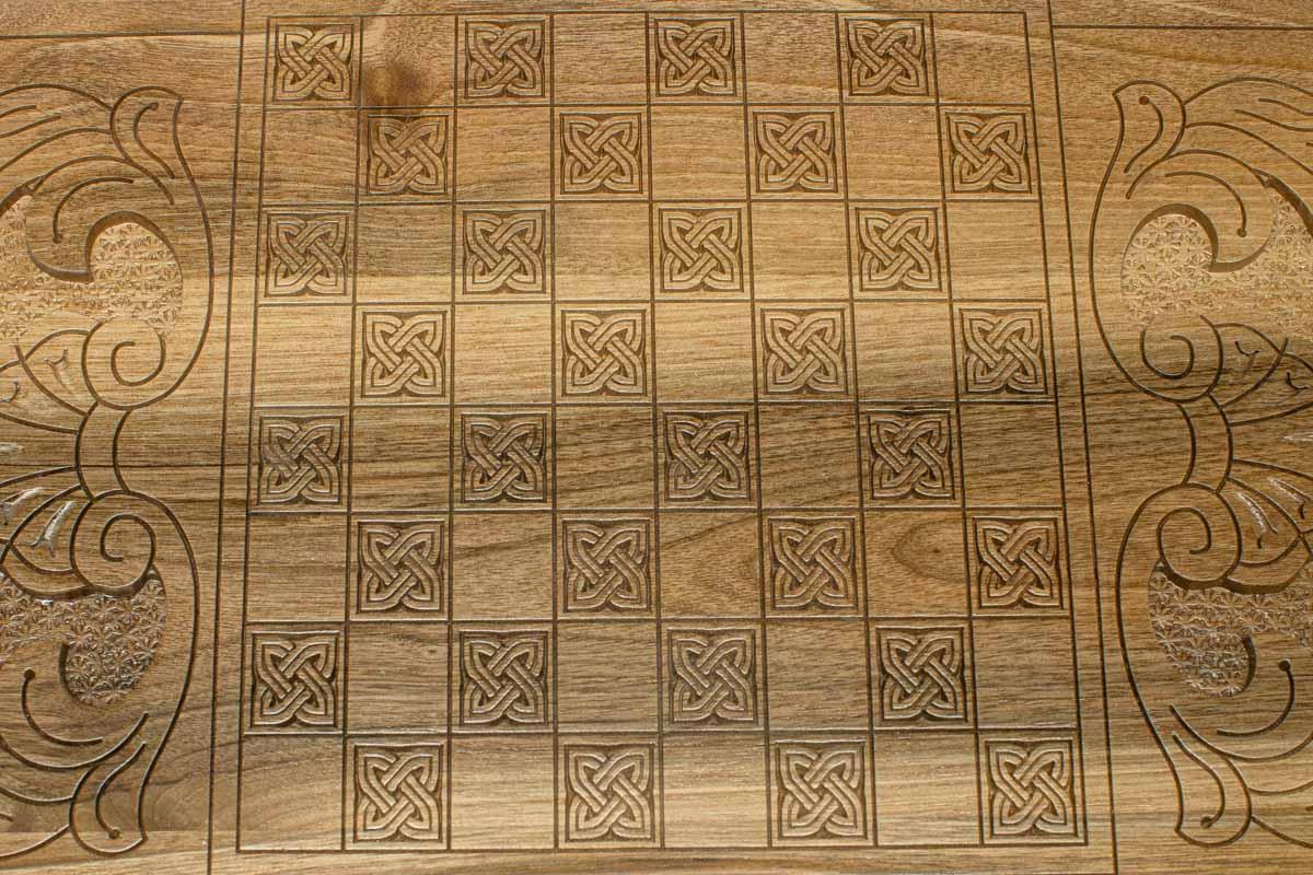 The backgammon board opened to show the wooden playing surface