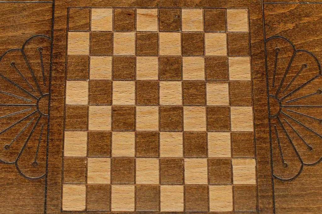 The mini backgammon board opened to show the wooden playing surface
