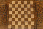 The mini backgammon board opened to show the wooden playing surface