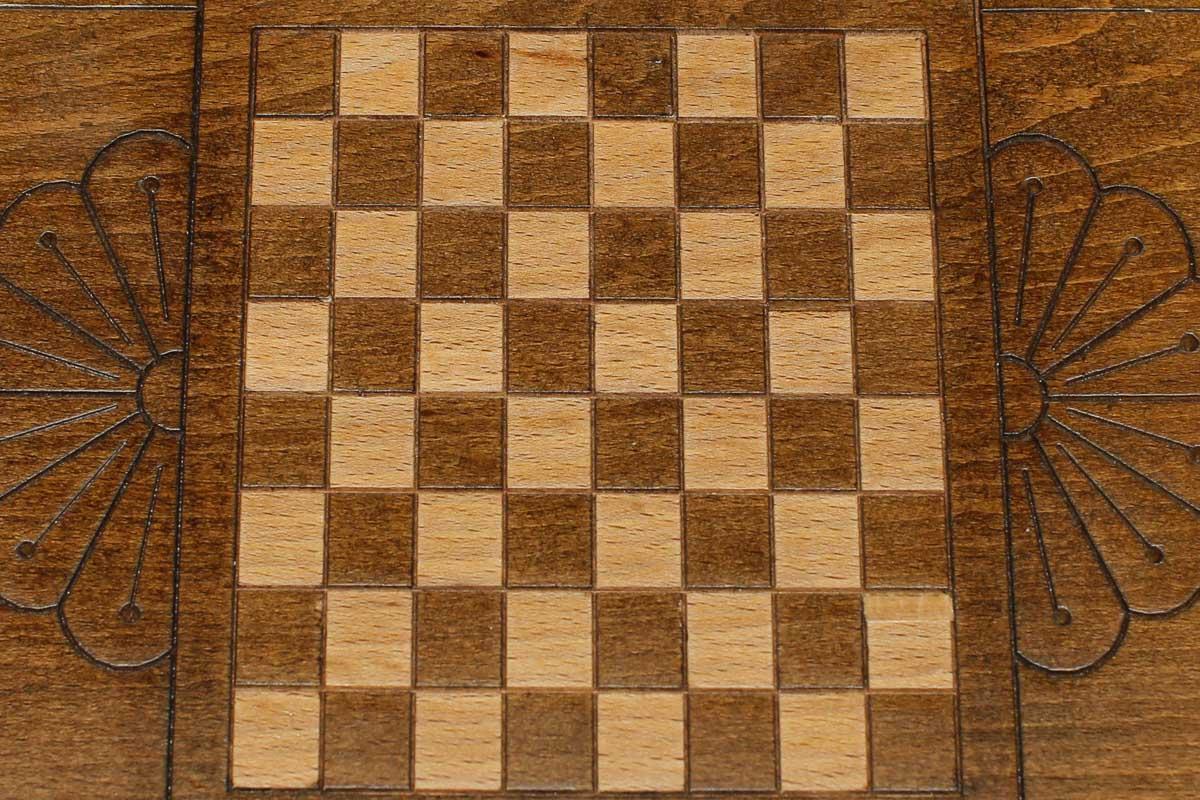 The mini backgammon board opened to show the wooden playing surface