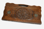 Carved beechwood backgammon board with a central carved ornament and bronze discs, propped open