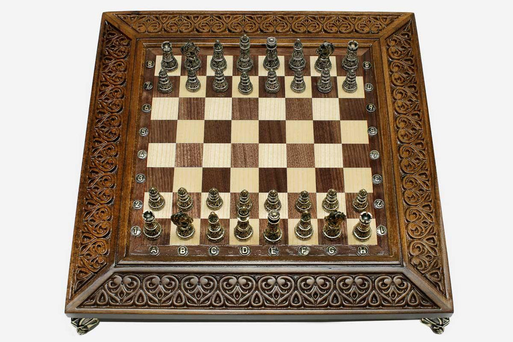 Carved chess set with bronze pieces folded with bronze hinges and clasps