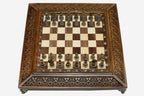 Carved chess set with bronze pieces folded with bronze hinges and clasps