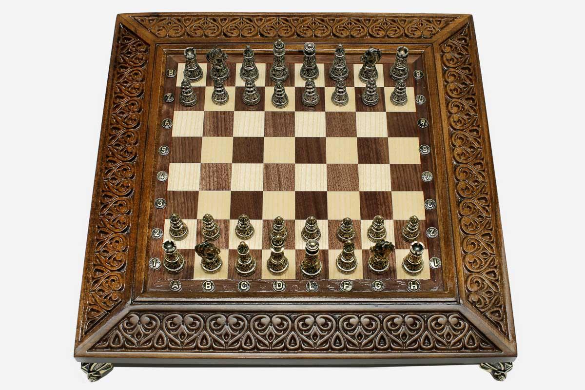 Carved chess set with bronze pieces folded with bronze hinges and clasps