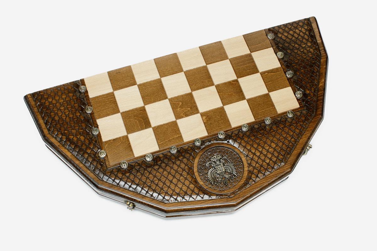 Angled view of the twelve-sided carved board with its light and dark wooden pieces