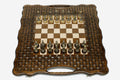 Luxury chess set with bronze pieces on a hand-carved lattice board