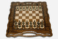 Luxury chess set with bronze pieces over carved diamond ornament