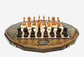 Luxury twelve-sided Armenian chess set with inlaid coat of arms and turned wooden pieces set up for play