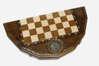 Angled view of the twelve-sided board with its bright and darkened bronze armies