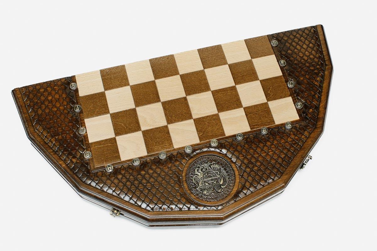 Angled view of the twelve-sided board with its bright and darkened bronze armies
