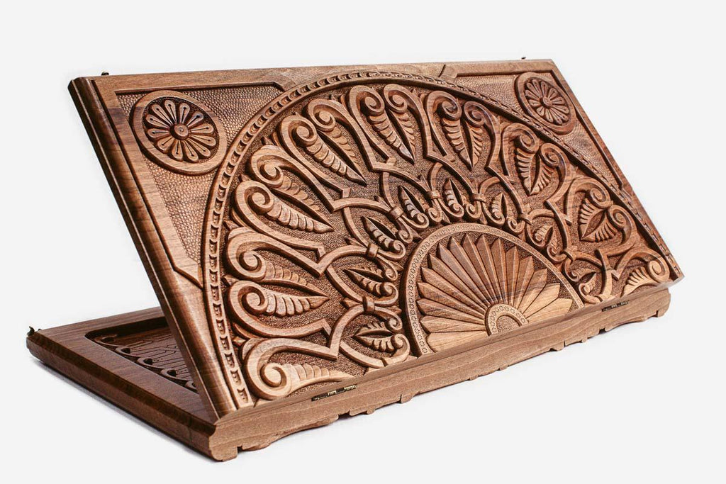 Master-carved walnut backgammon board with a grand fan ornament and a carry handle, propped open