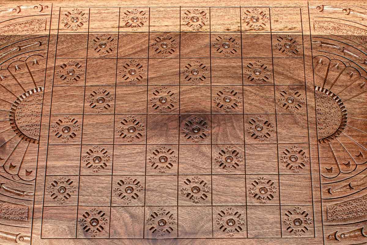 The backgammon board opened to show the wooden playing surface