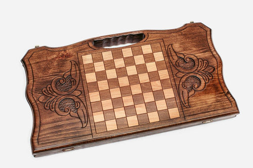 Backgammon board on its reverse, inlaid pale and dark chequered panel between scrolled leaf cartouches, cut-out grip