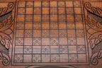 Angled view of the Saint George carved backgammon board