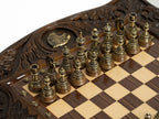 Brass chess pieces set up on the wooden board