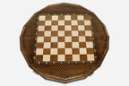 Angled view of the sixteen-sided chess board with its beech and walnut pieces