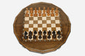 Luxury sixteen-sided chess set with lattice-carved borders and turned wooden pieces set up for play