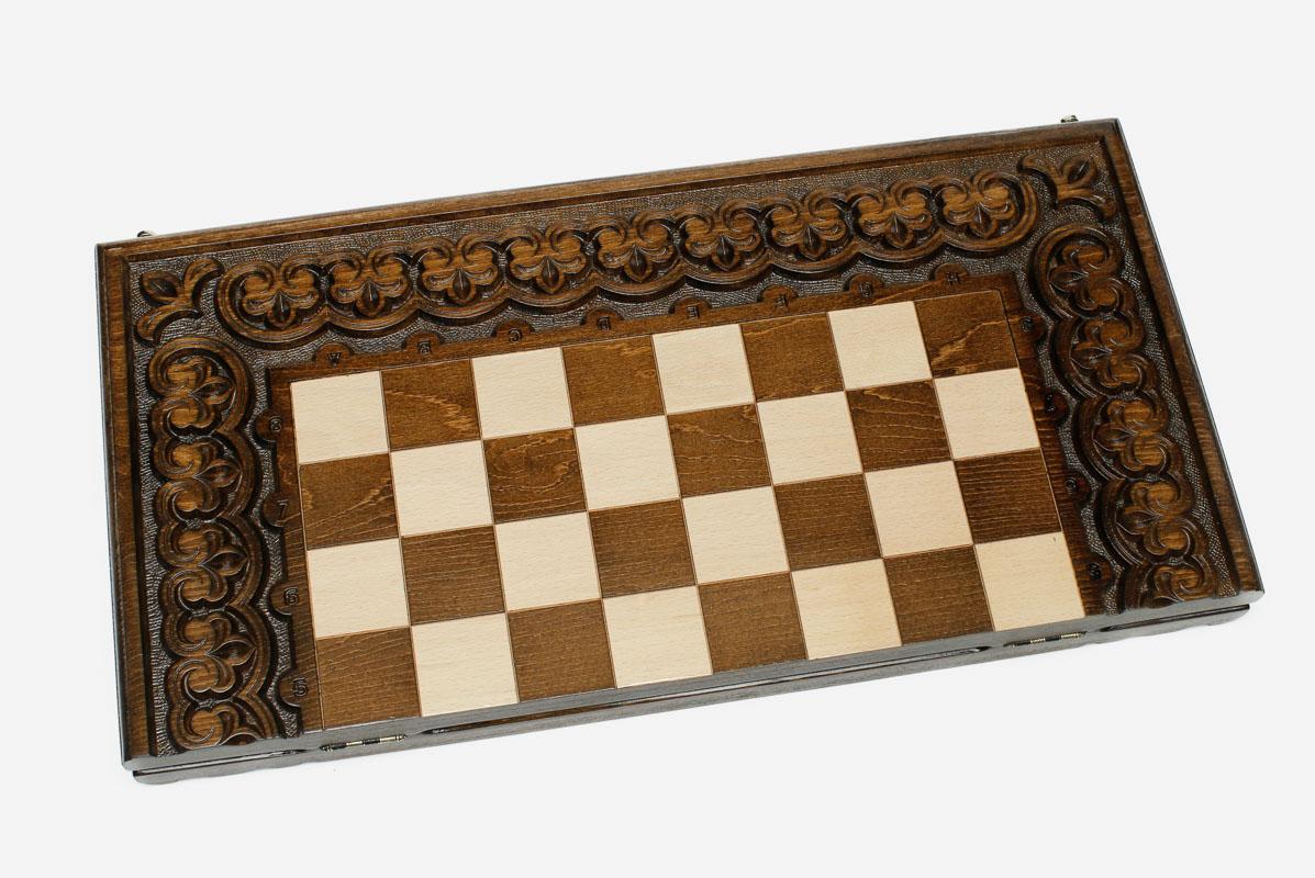 Blossoms and stems carved around the wooden chessboard