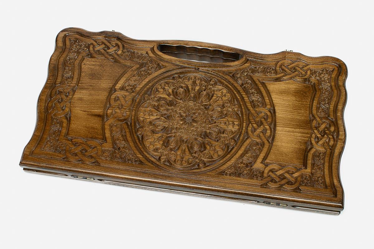 Carved beechwood backgammon board with a grand carved ornament and interlace panels, propped open