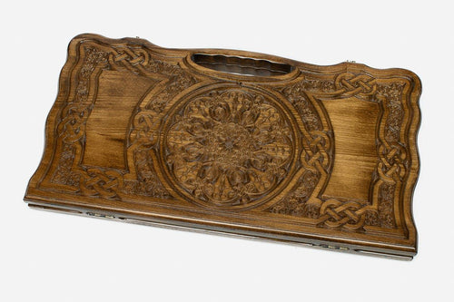 Carved beechwood backgammon board with a grand carved ornament and interlace panels, propped open