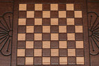 Side view of the folded travel board with its carry handle