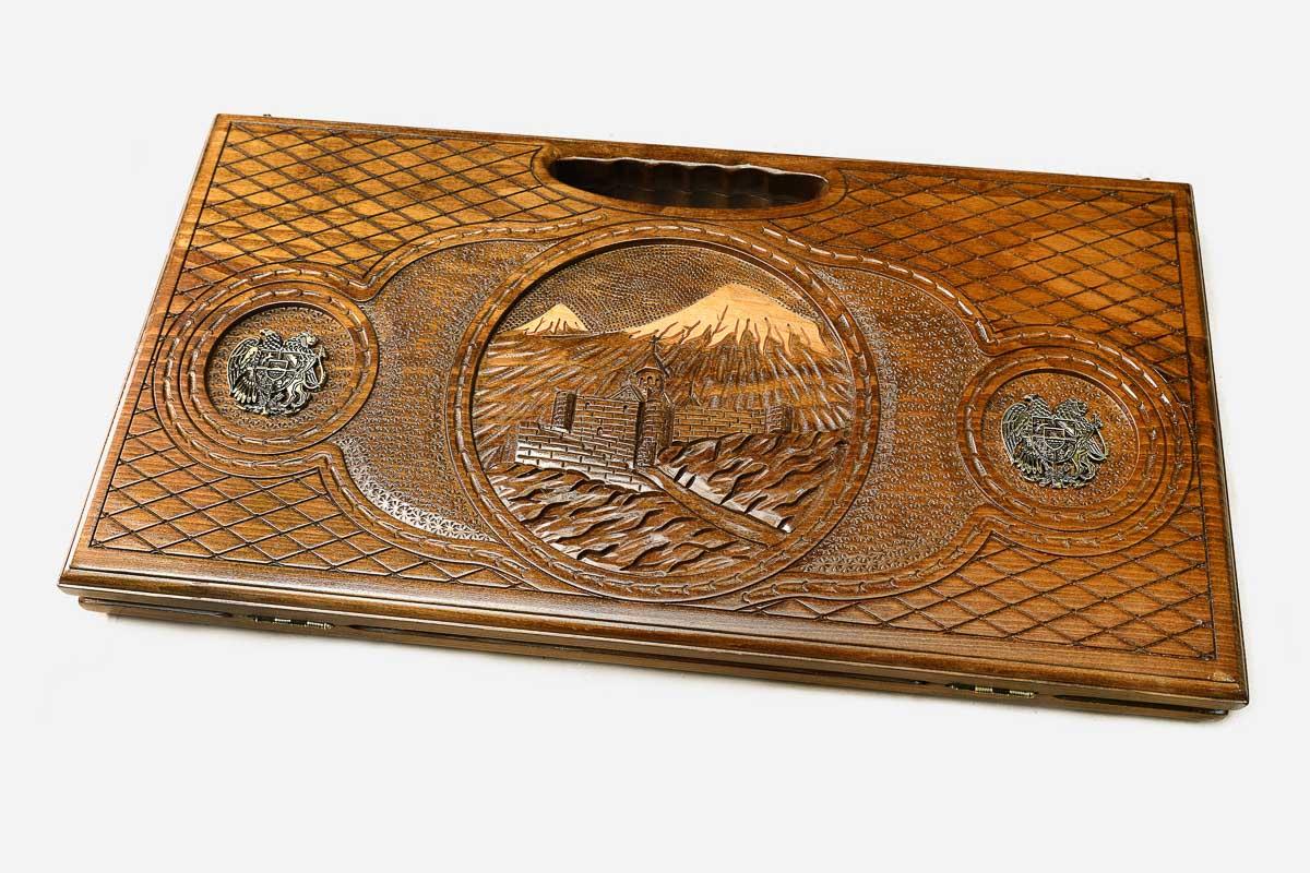 The backgammon board opened to show the wooden playing surface