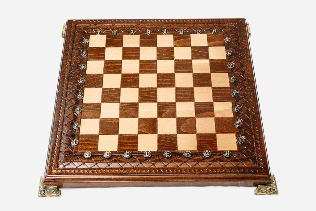Hand-carved chess set shown folded with bronze clasps
