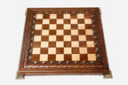 Hand-carved chess set shown folded with bronze clasps