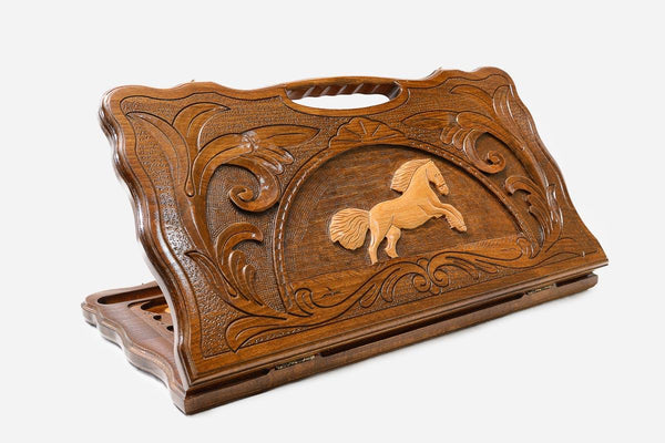 Carved beechwood backgammon board with a leaping horse and a carry handle, propped open