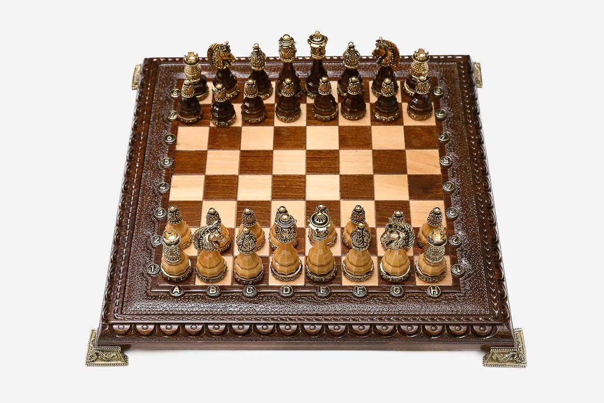 Luxury chess set with figural bronze pieces on a carved board