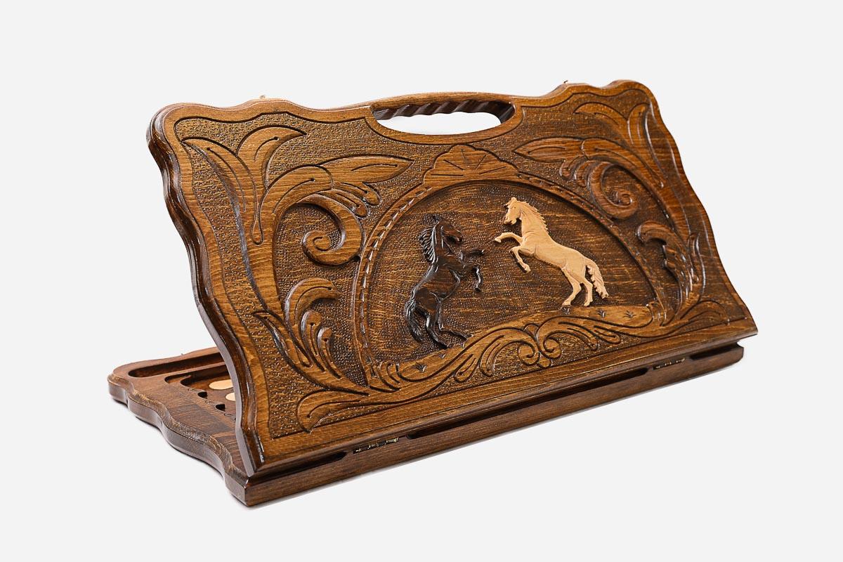 Carved beechwood backgammon board with two rearing horses and a carry handle, propped open