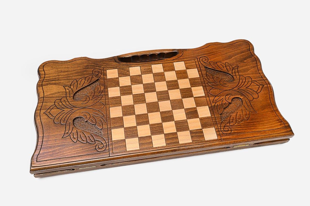 Angled view of the serpent carved backgammon board
